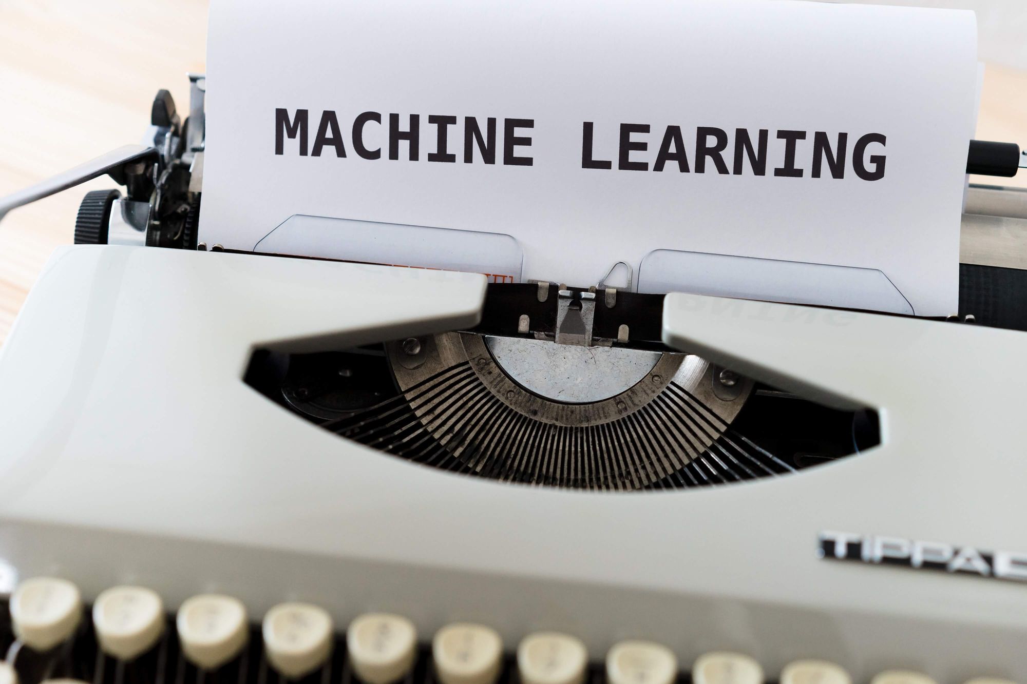 Machine learning in FP&A - image of a typewriter printing a page that says 'machine learning'